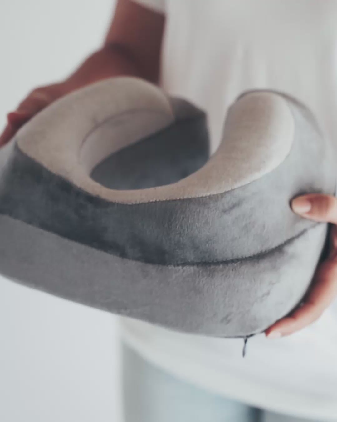 Squeezing the pillow to show how buttery soft the fabric and memory foam are.