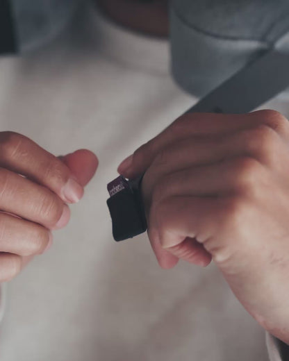 Stretching chin strap up, over, and across the pillow to secure on the other side. Traveler places chin on strap and rests peacefully