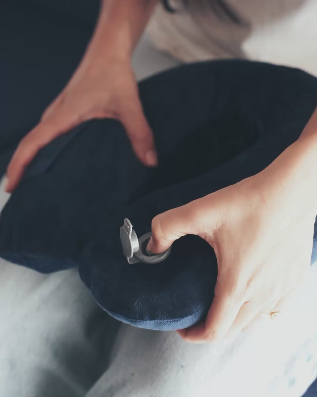 Press button to release air from the inflatable neck pillow 